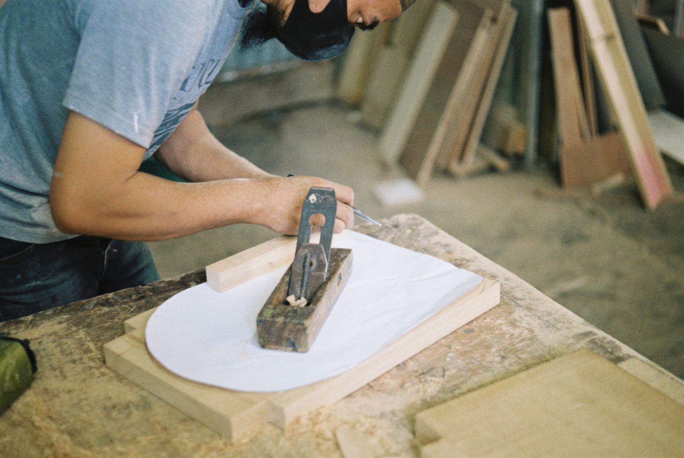 A hand plane working the edge of a door